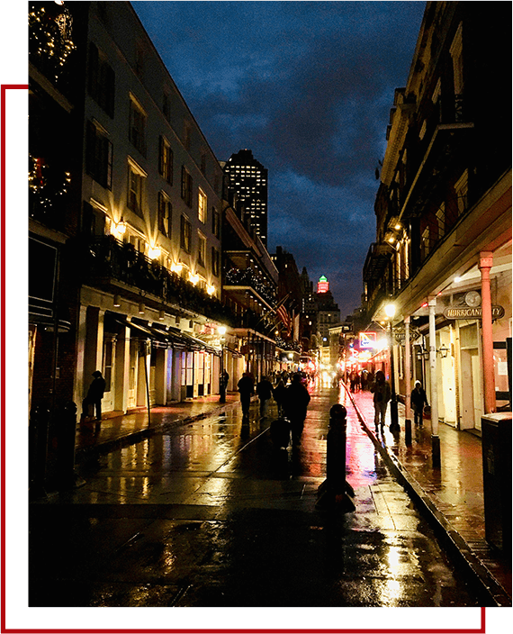 A street with people walking on it and buildings in the background.